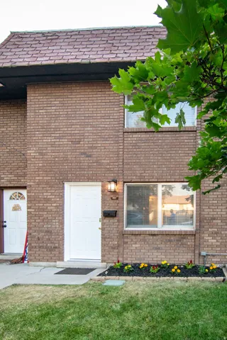 Brick exterior with a red shingle roof