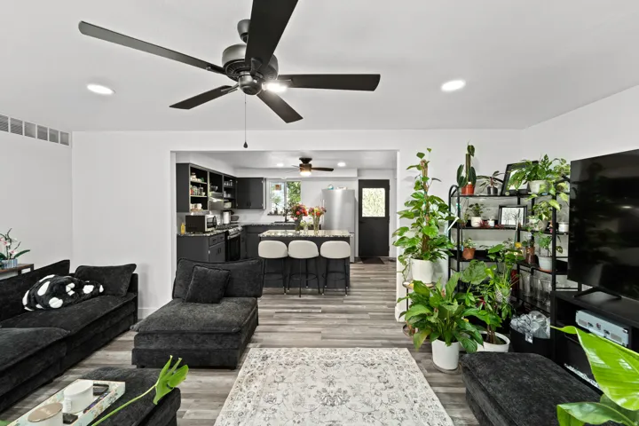 Open concept living space featuring wood-finish flooring, recessed lighting, and a modern ceiling fan