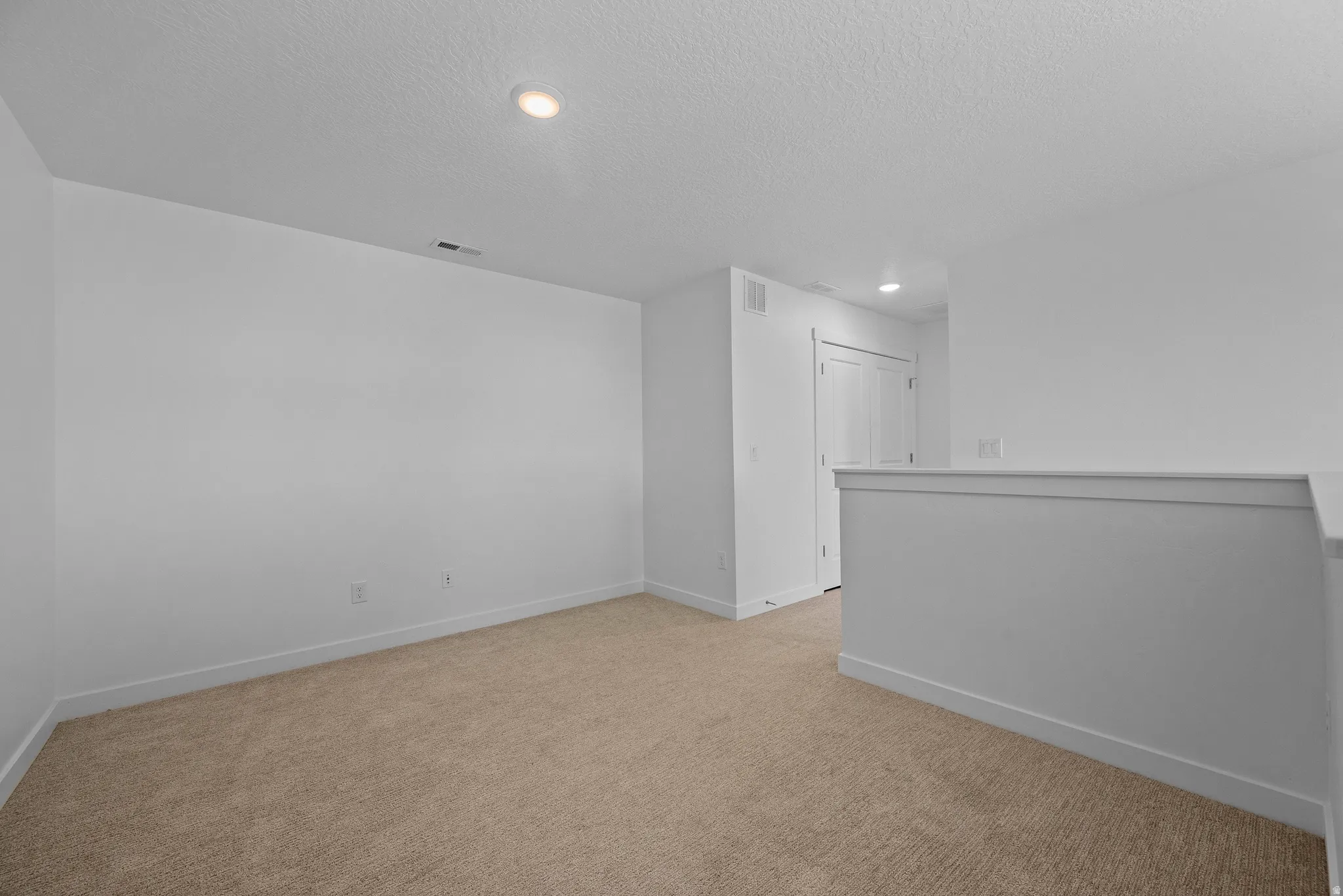 Neutral-toned carpeting complementing white walls and trim