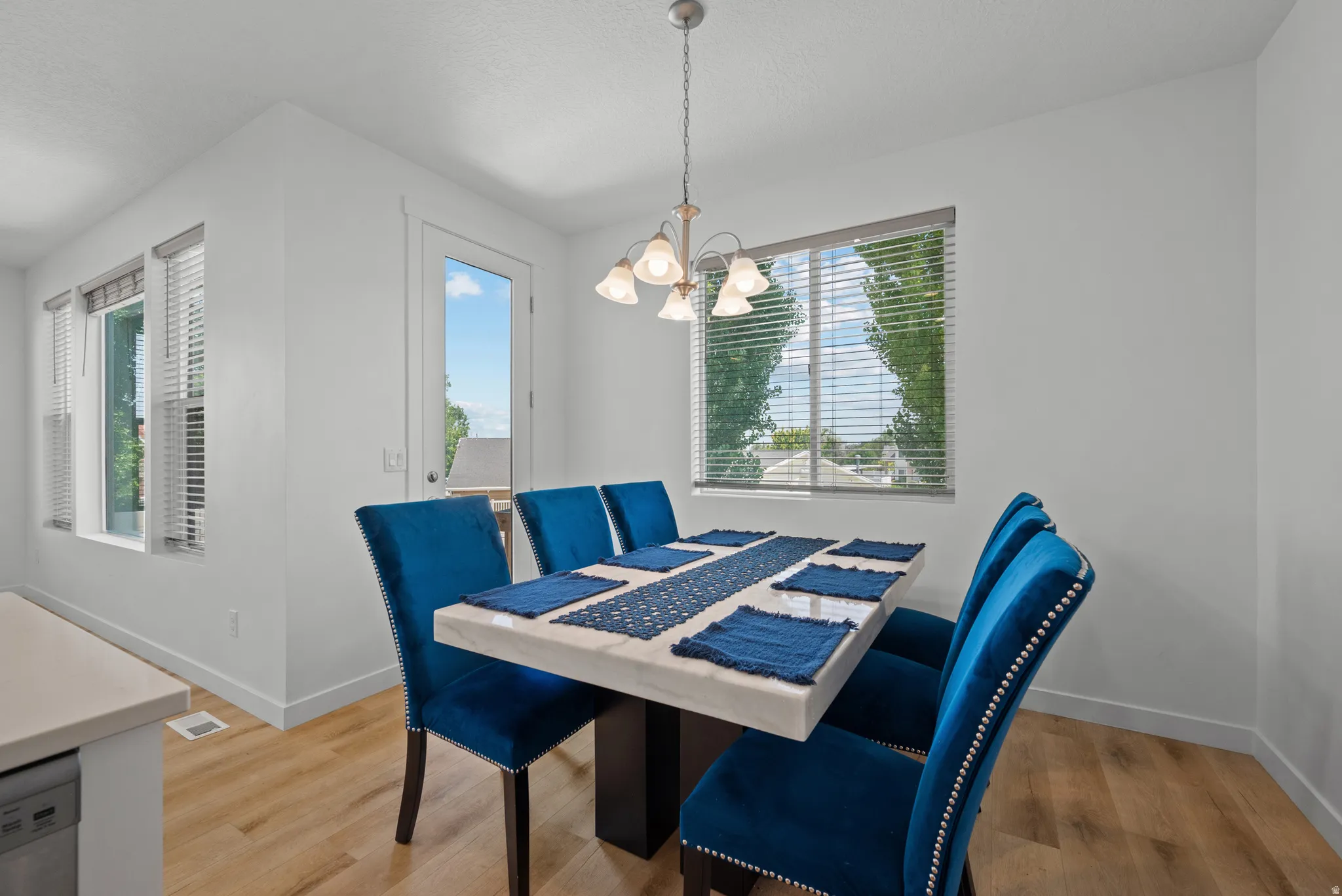 Dining area featuring light wood-finish flooring and white walls