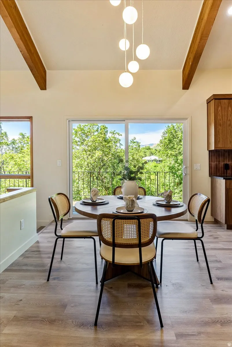 Vaulted ceiling with exposed wood beams and a contemporary multi-globe chandelier
