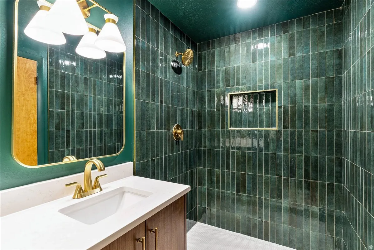 Contemporary bathroom featuring a vanity with a white countertop and gold-toned fixtures