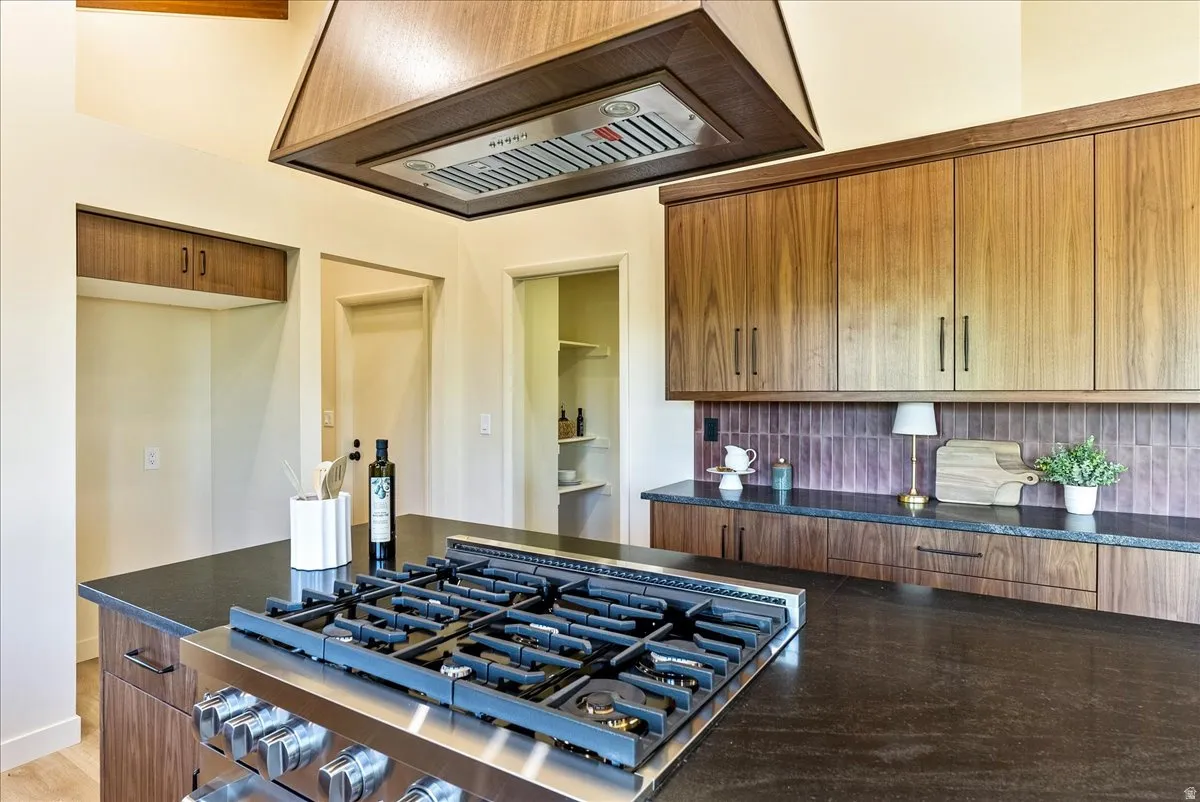 Kitchen featuring a stainless steel gas range on a dark countertop island