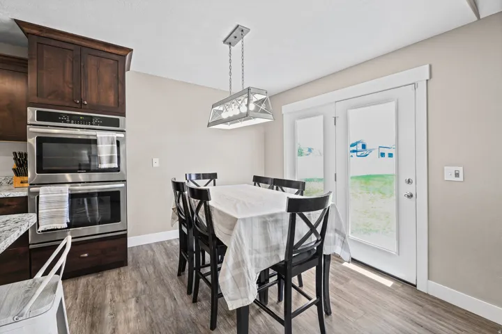 Large semi-formal dining area with french doors out a beautiful backyard.