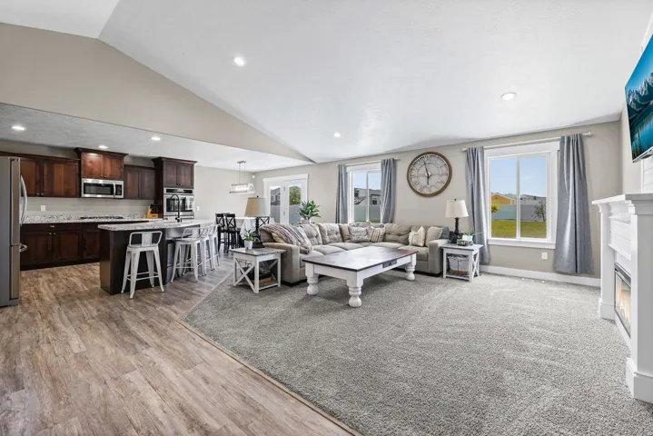 Open-concept living space featuring a spacious kitchen, dining area, and living room