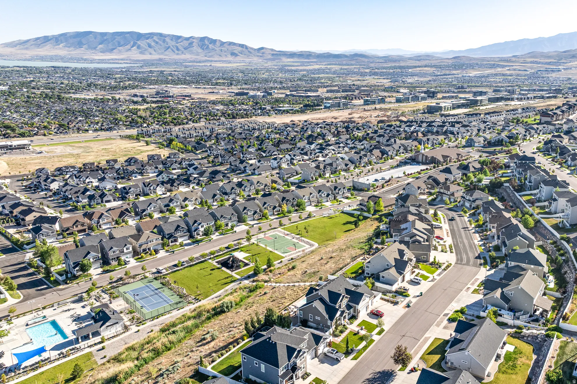 Aerial view of community pool, tennis court and basketball court