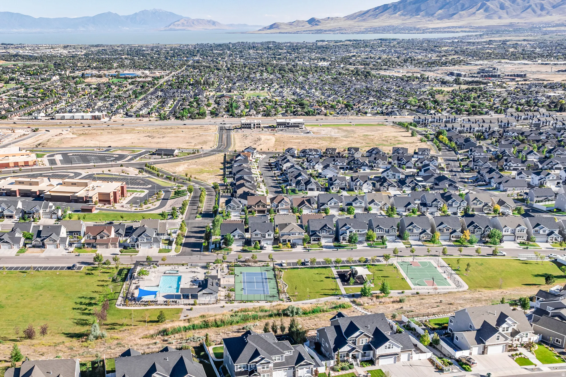 Aerial view of community pool, tennis court and basketball court