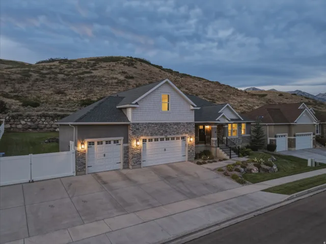 Crafted exterior featuring stone accents, shake siding, and a two-car garage
