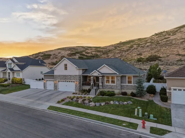 Stone and siding exterior with a multi-car garage