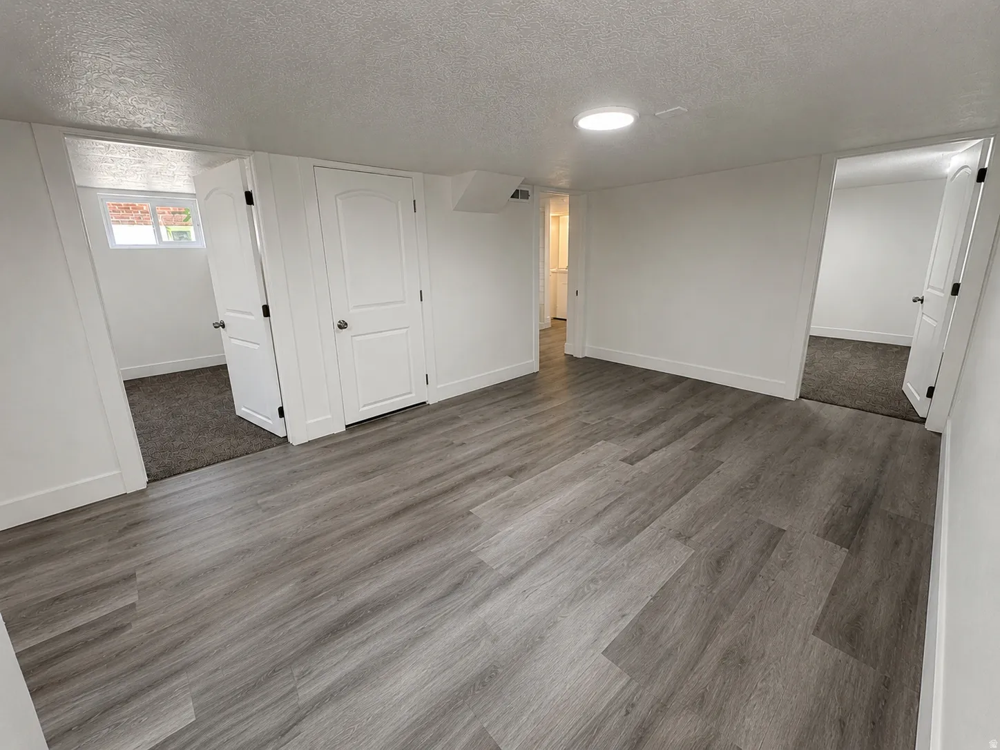 Open area featuring wood-finish flooring and recessed lighting