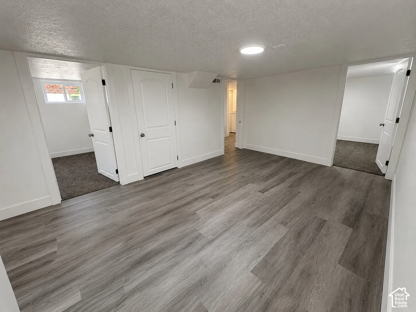 Open area featuring wood-finish flooring and recessed lighting