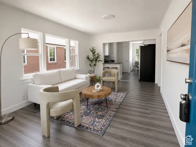 Bright living area with wood-finish flooring, white walls, and a recessed ceiling light