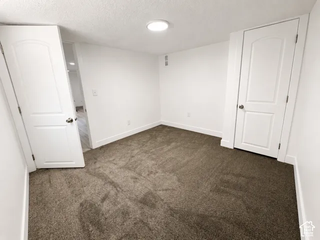 Neutral tone carpeting with white baseboards