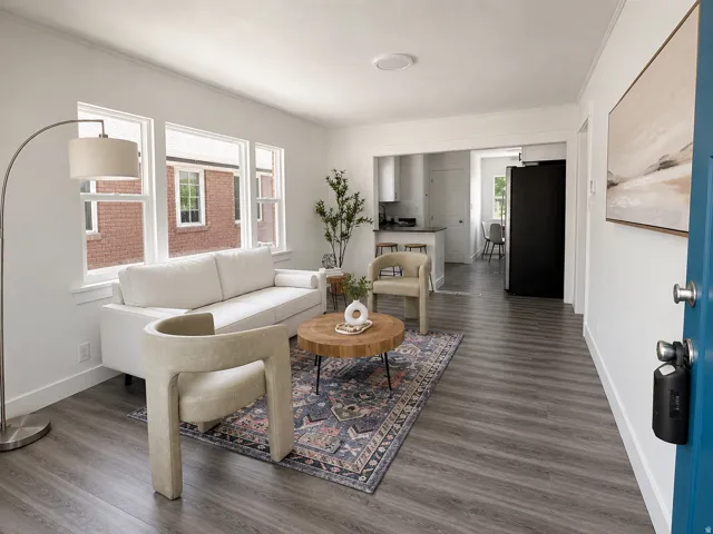 Bright living area with wood-finish flooring, white walls, and a recessed ceiling light