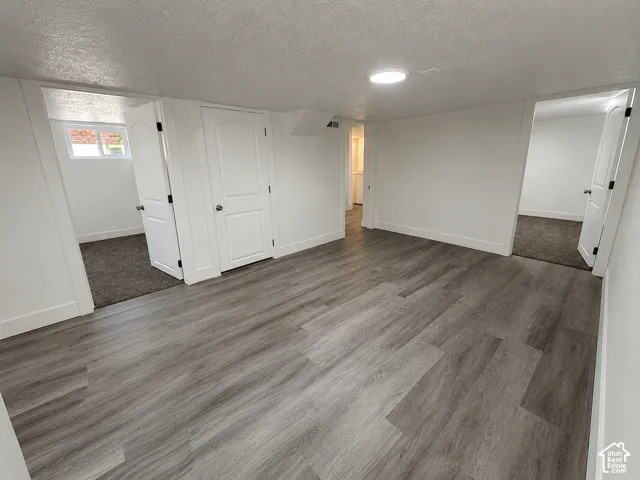 Open area featuring wood-finish flooring and recessed lighting