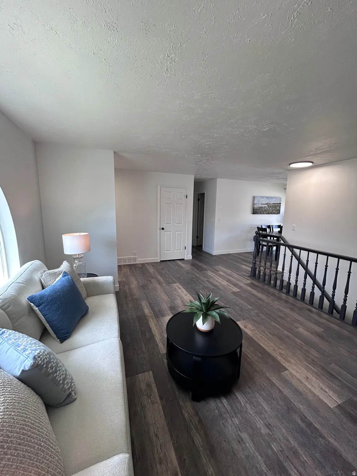 Open concept living area featuring wood-finish flooring throughout