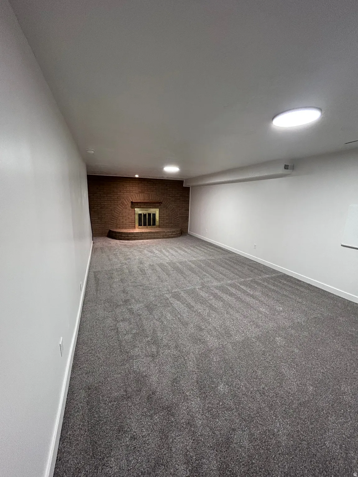 Spacious room with new gray carpeting