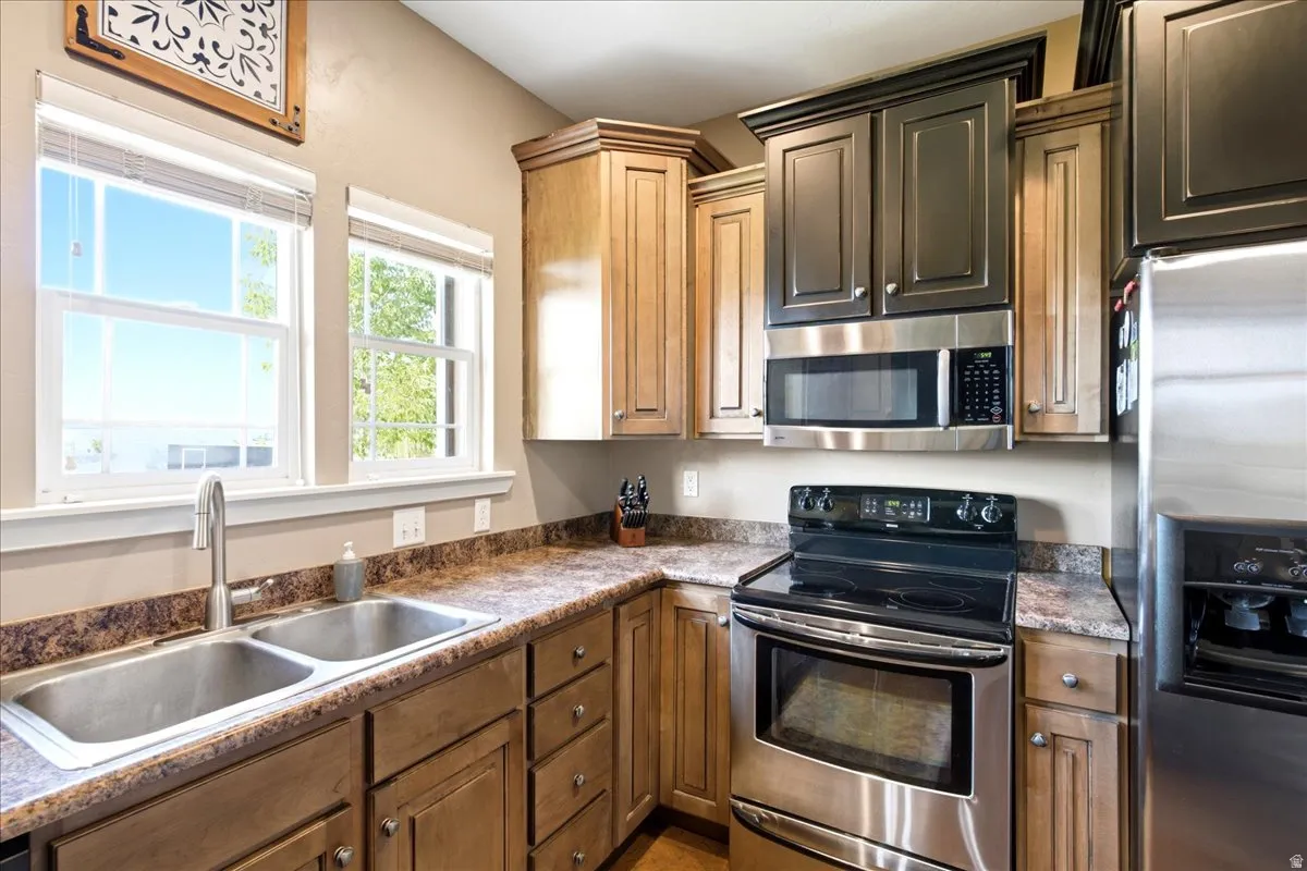 View 2 of kitchen with stainless steel countertops and two pantries