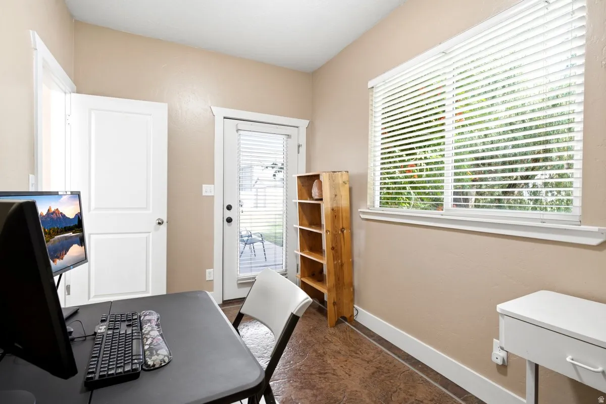 Attached office/craft room off the primary bedroom provides outdoor access.