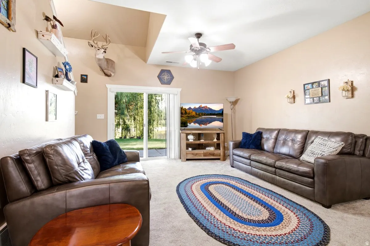 Living area featuring a sliding glass door with gorgeous views to the private backyard, vaulted ceiling