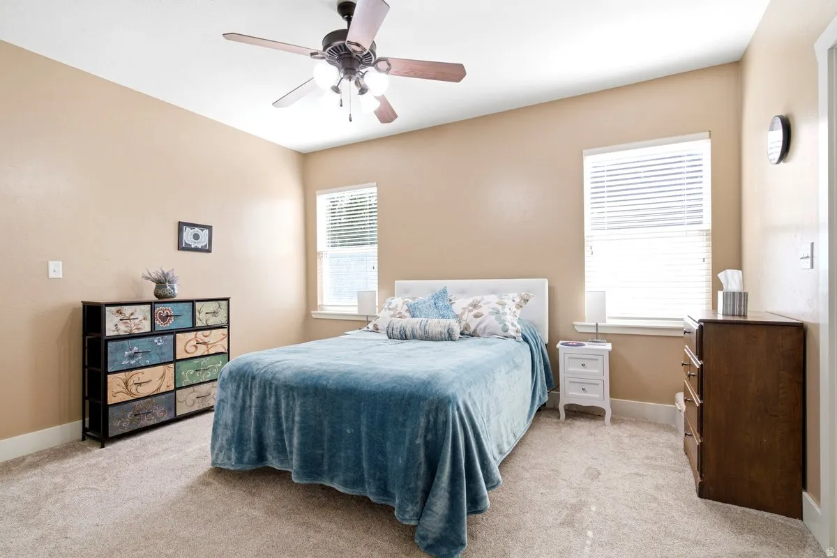 Generously sized primary bedroom with double closets and an attached office/craft space and access to backyard.