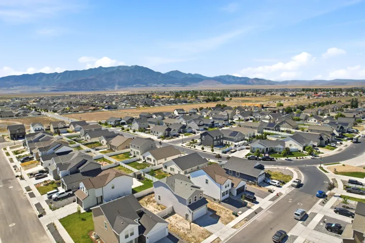 Aerial perspective showcasing a residential community with distant mountain ranges