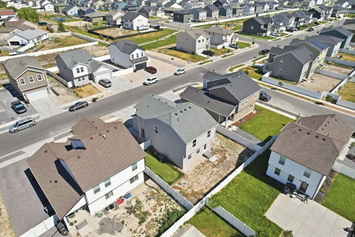 Aerial perspective showcasing a residential community with asphalt streets and individual properties