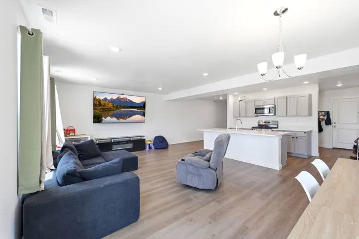 Open-concept living area featuring wood-finish flooring