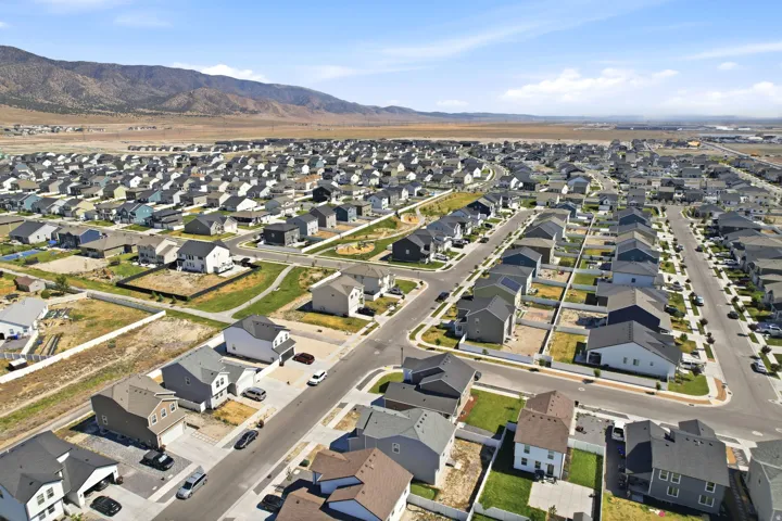 Expansive aerial perspective showcasing a residential development with numerous single-family homes