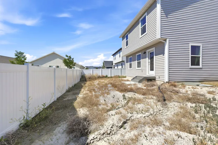 Rear exterior featuring gray horizontal siding and white trim