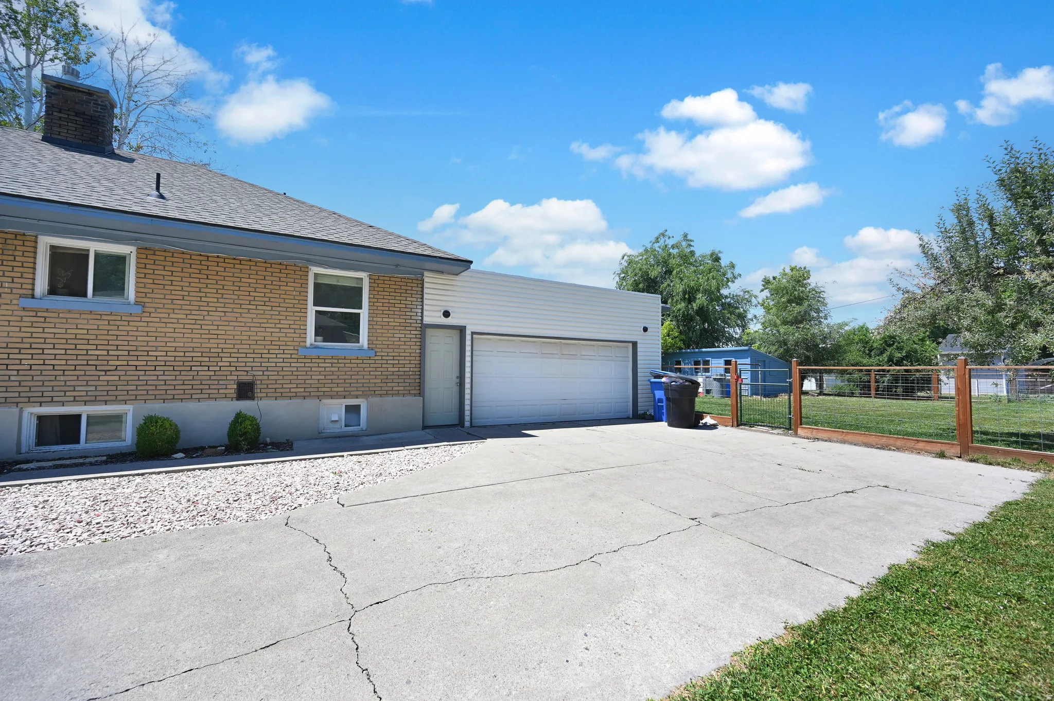 Concrete driveway leading to a two-car garage with a side entry door