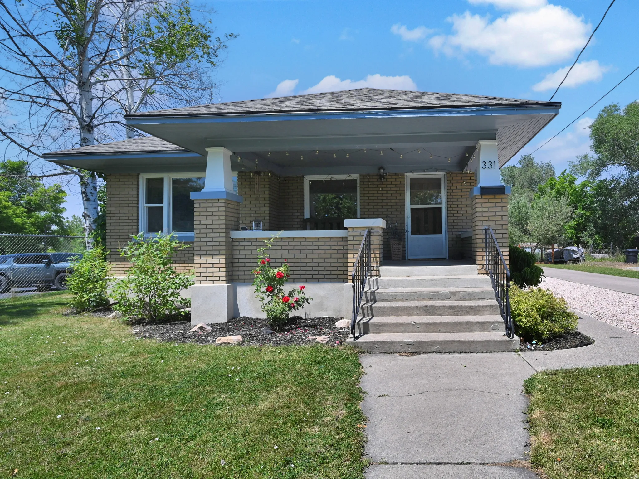 Brick exterior featuring a covered porch