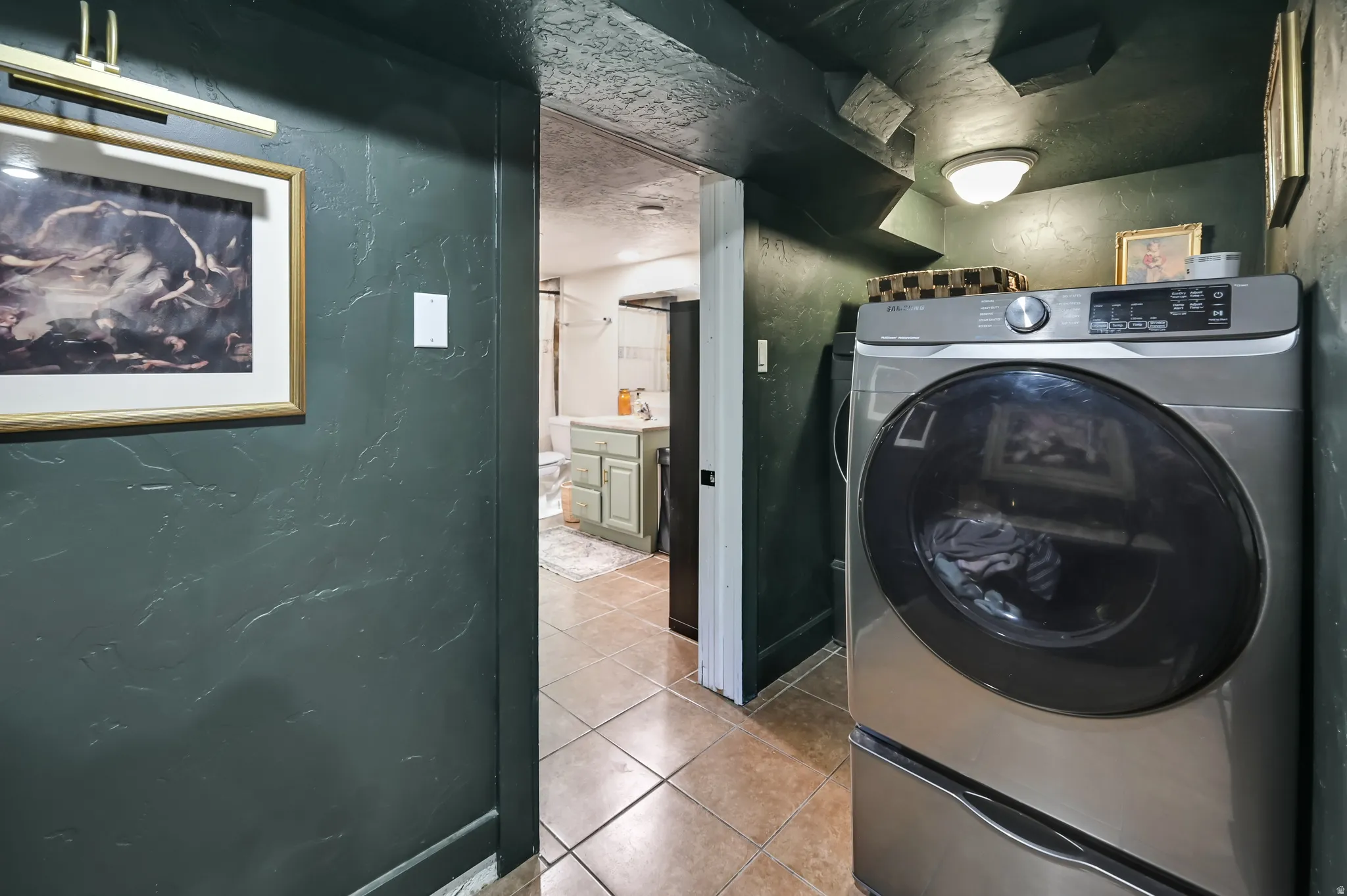 Dedicated laundry area featuring tile flooring