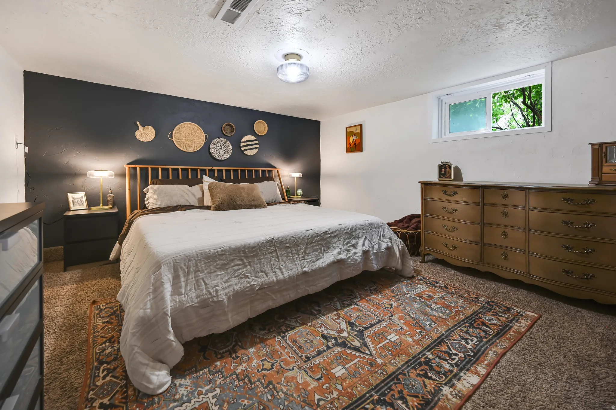 Spacious bedroom featuring a prominent accent wall