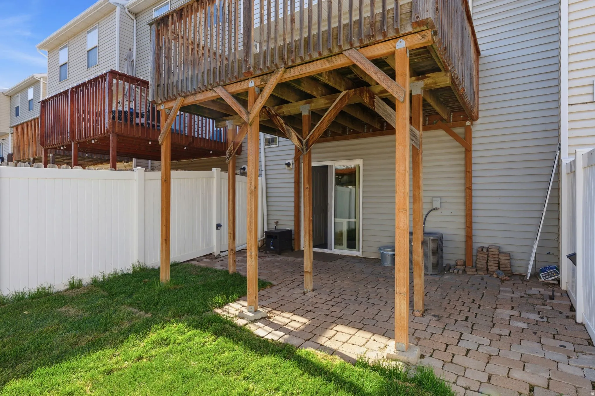 Two-story wood deck over a paver patio