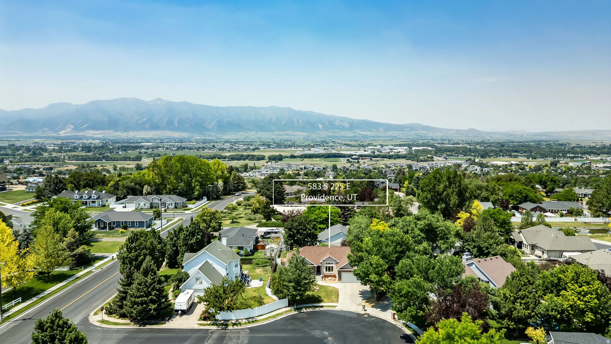 Aerial perspective showcasing a residential area with varied home styles and mature trees