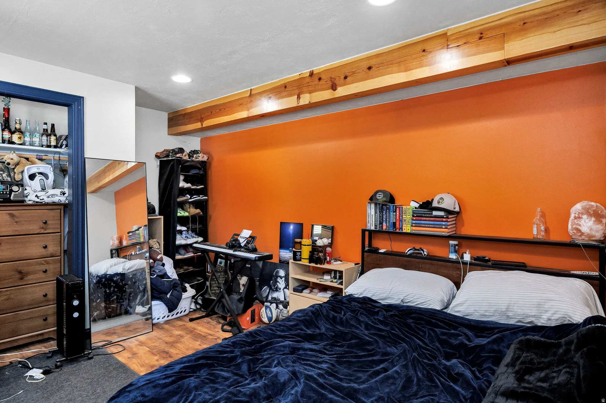 Bedroom with wood-finish flooring, recessed lighting, and an exposed wood beam