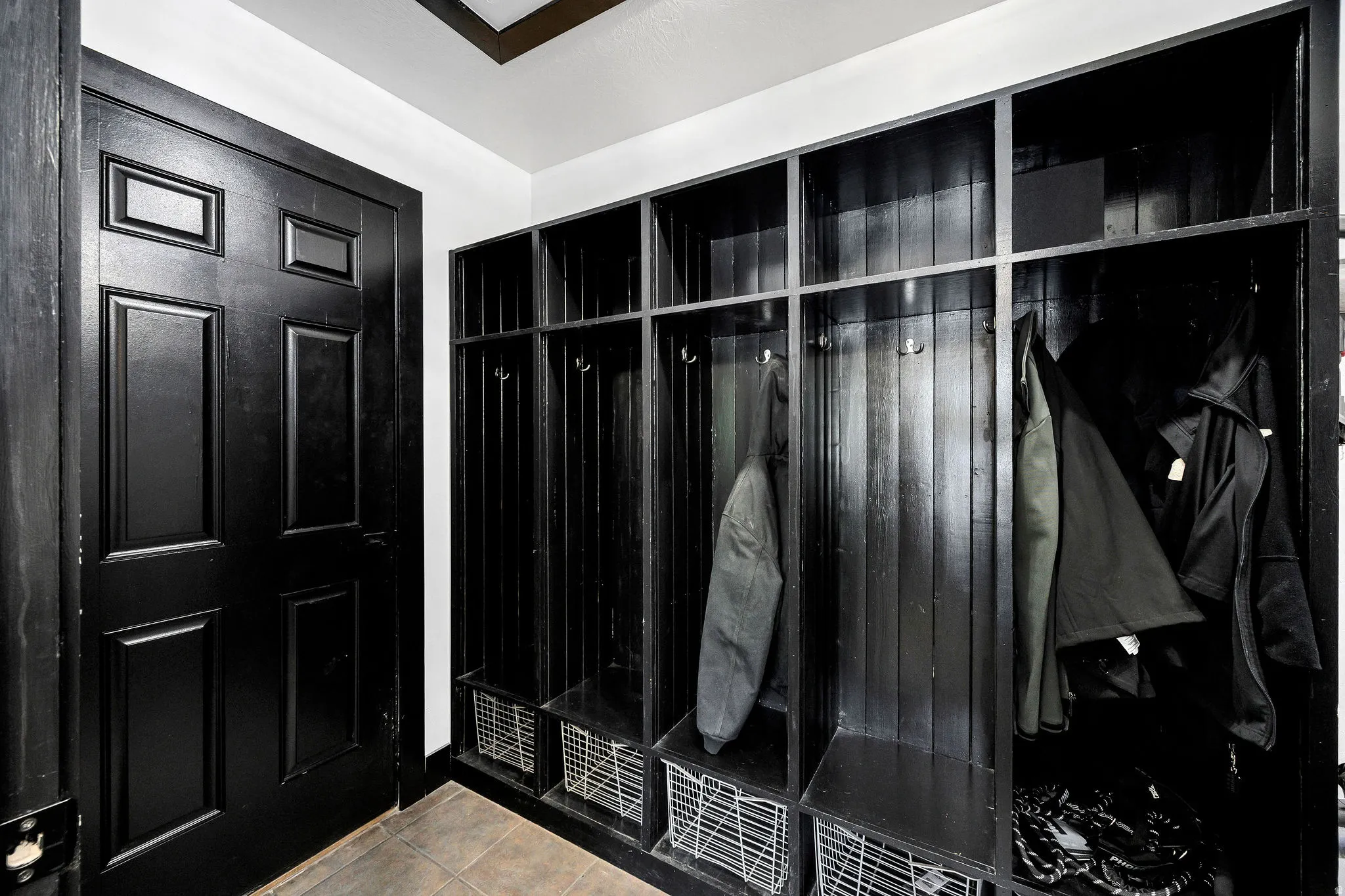 Built-in mudroom lockers with integrated storage, hooks, and shelving