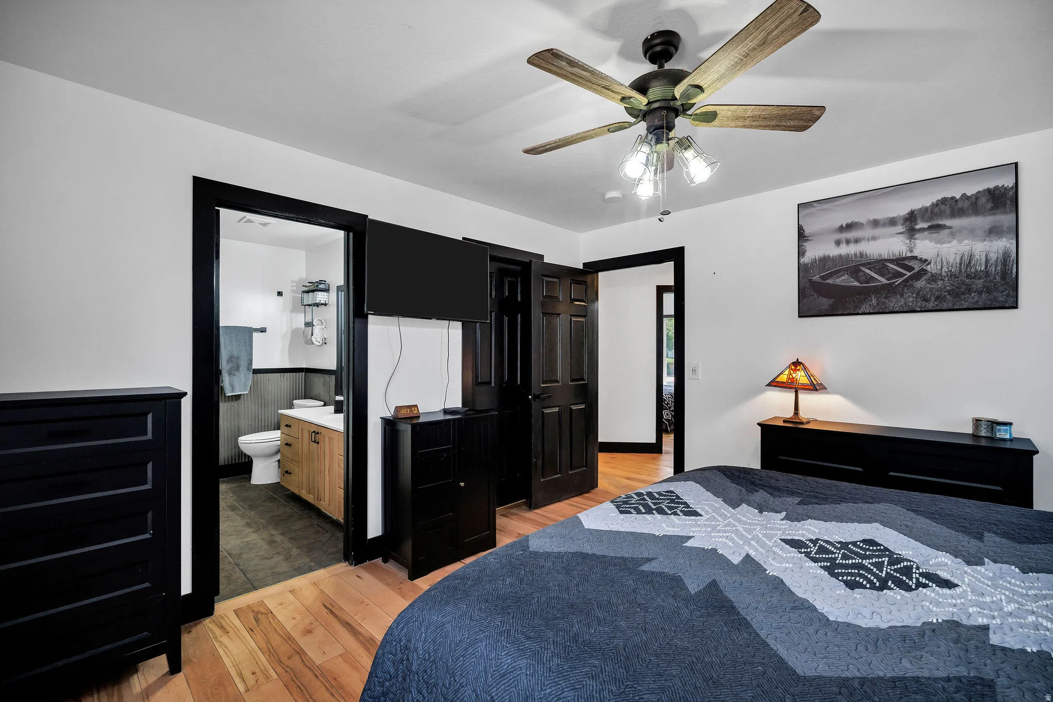 Hardwood flooring complements the bright white walls and dark trim