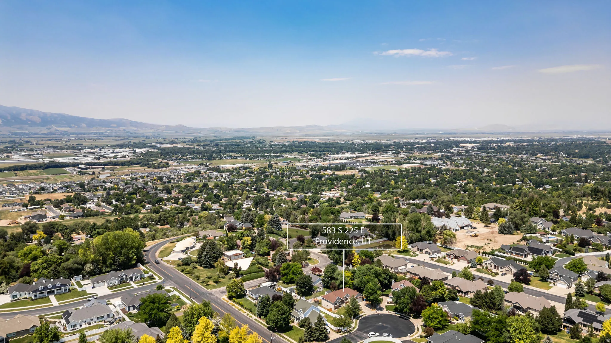 Aerial perspective highlighting the property within a residential neighborhood