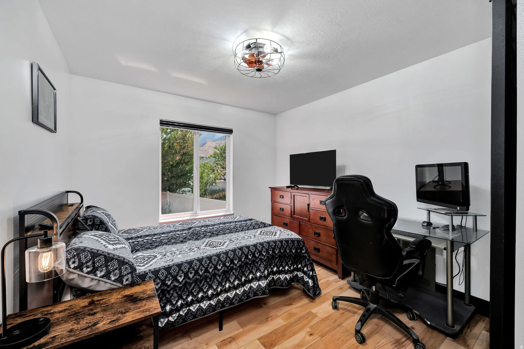 White walls and wood-finish flooring create a bright atmosphere