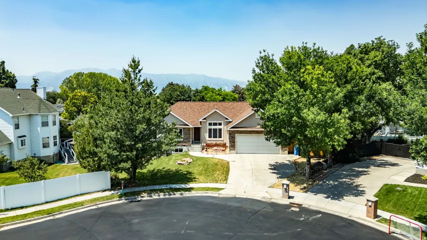 Single-story residence featuring a two-car garage, concrete driveway, and a shingle roof