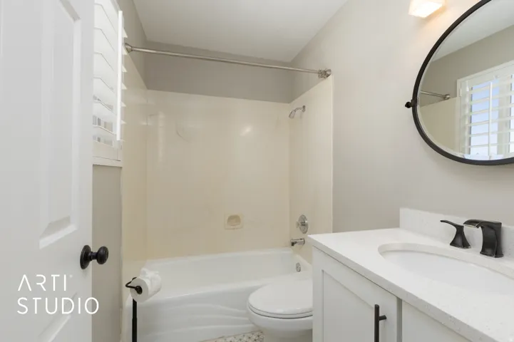 Upstairs master bathroom featuring a quartz countertop