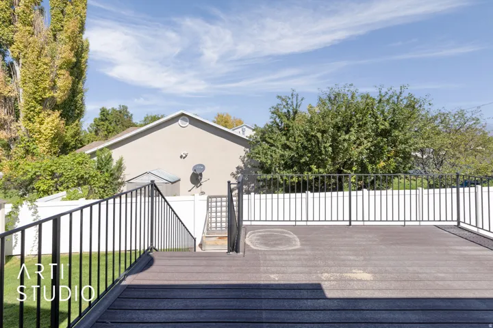 Spacious composite deck featuring dark-toned decking and black metal railings