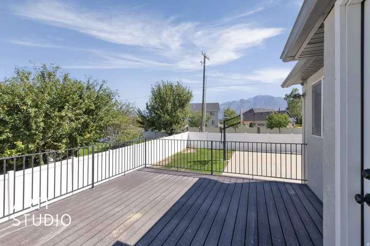 Expansive outdoor deck with composite decking and black metal railings