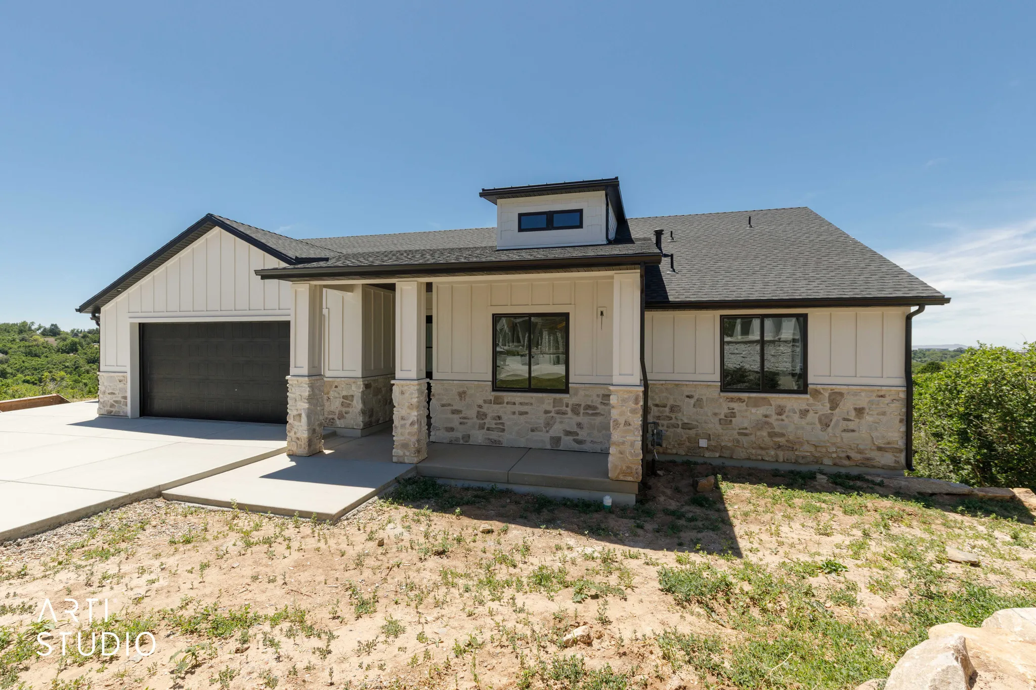 Modern ranch-style home featuring a stone and vertical siding facade