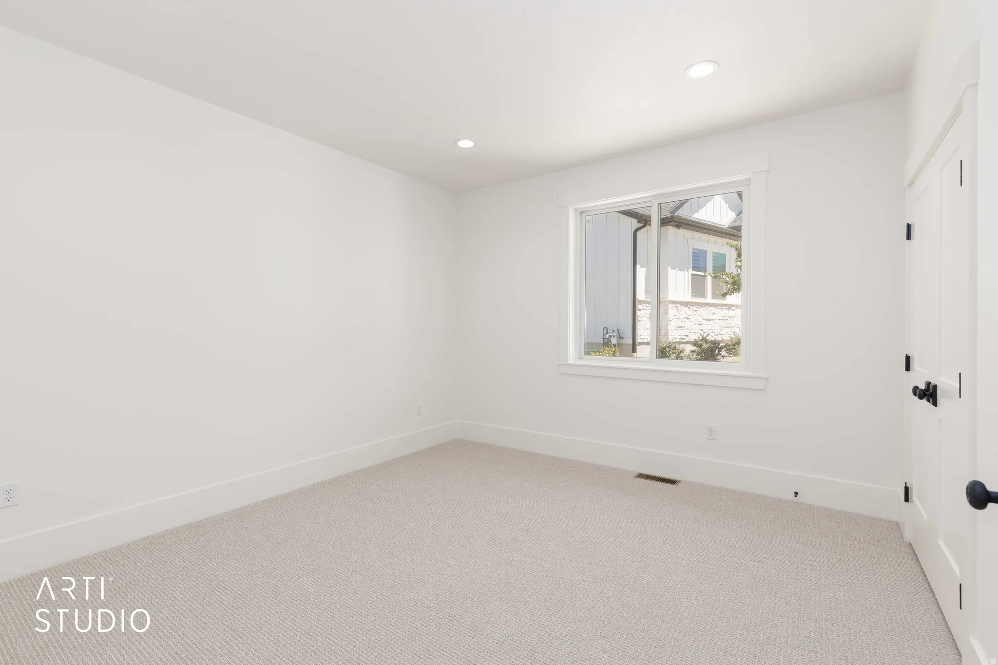 Neutral-toned carpeting complements the white walls and trim