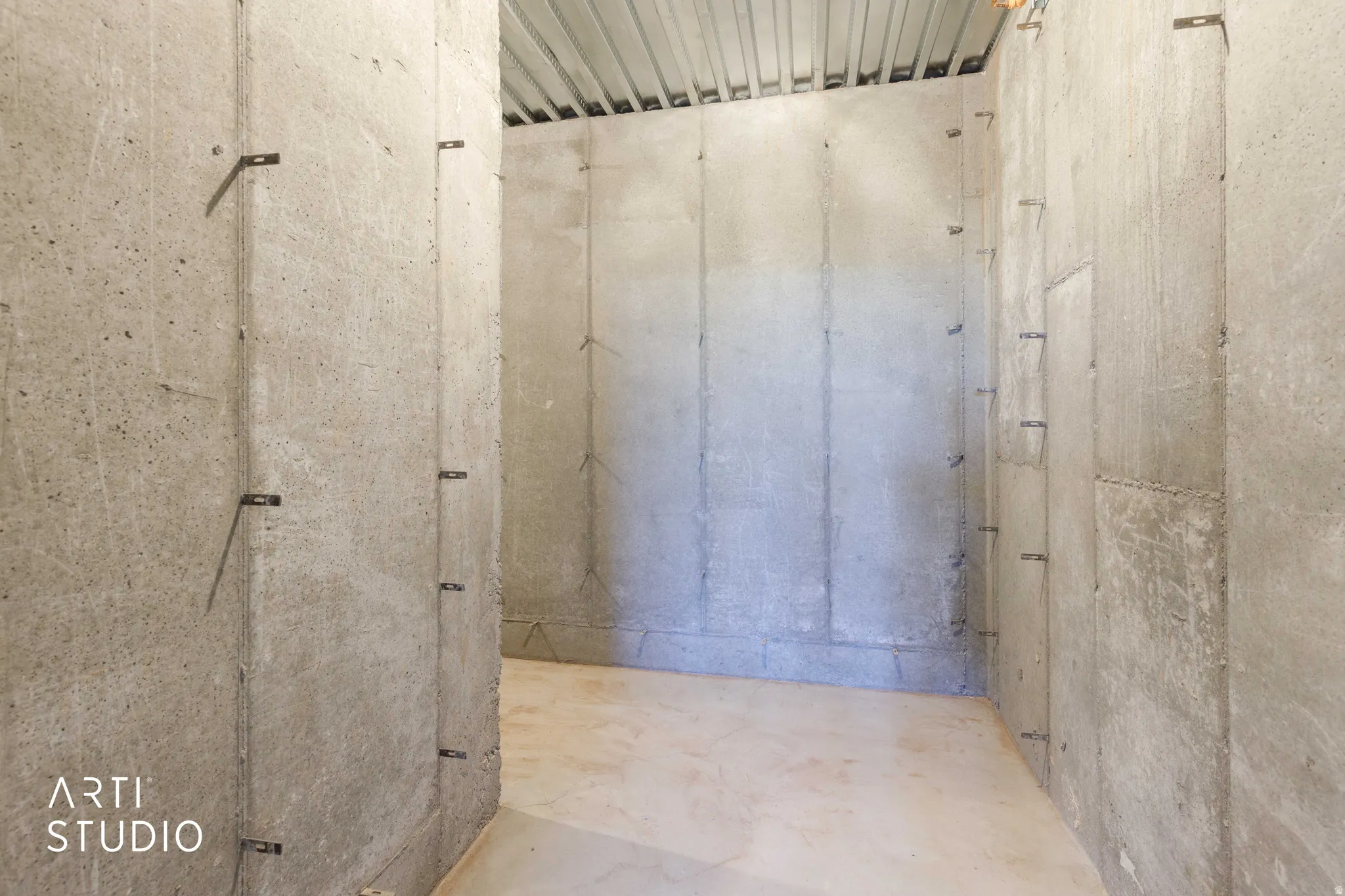 Concrete wall construction with exposed corrugated metal ceiling