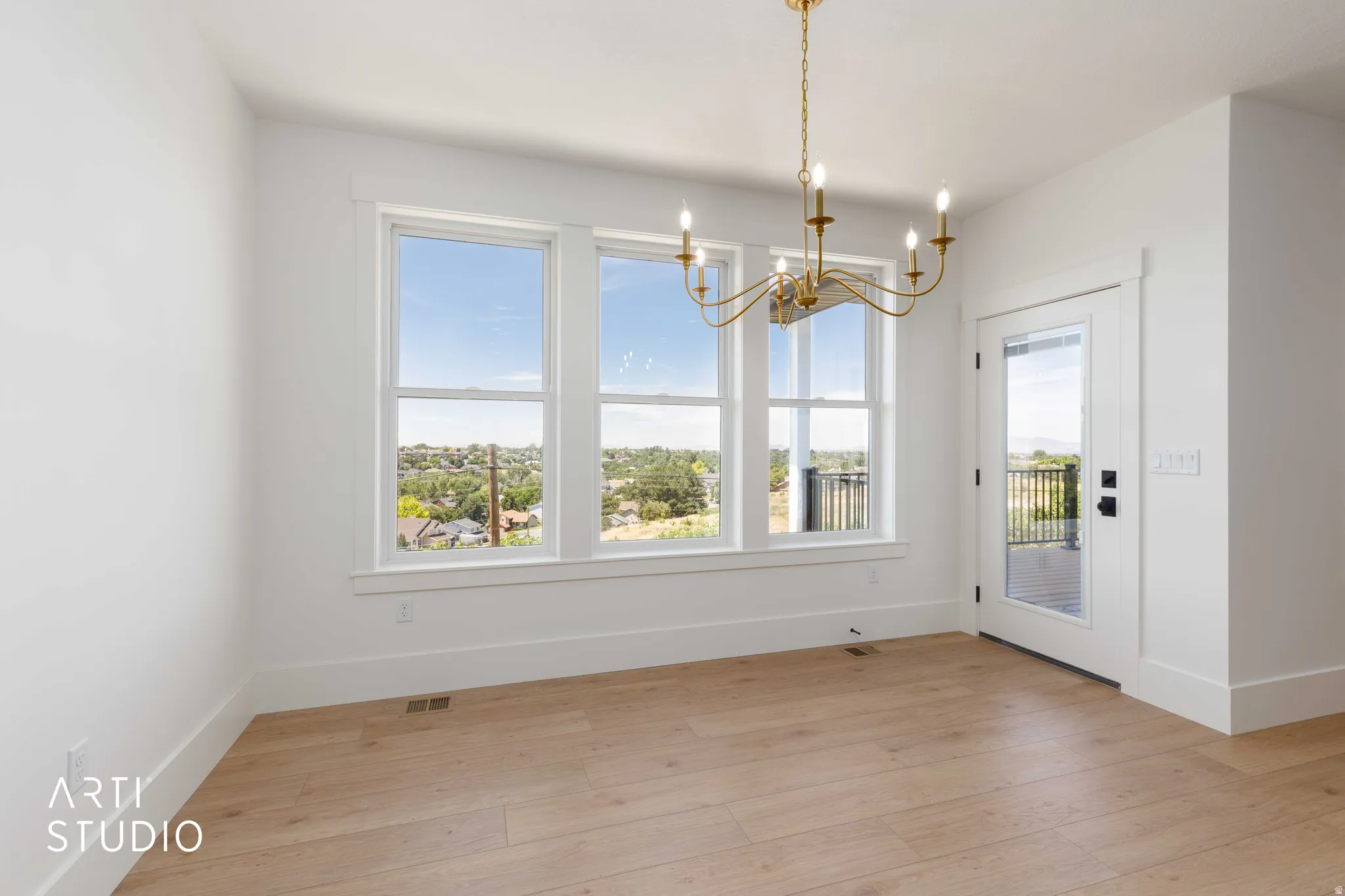 Light wood-finish flooring complements the white walls and trim