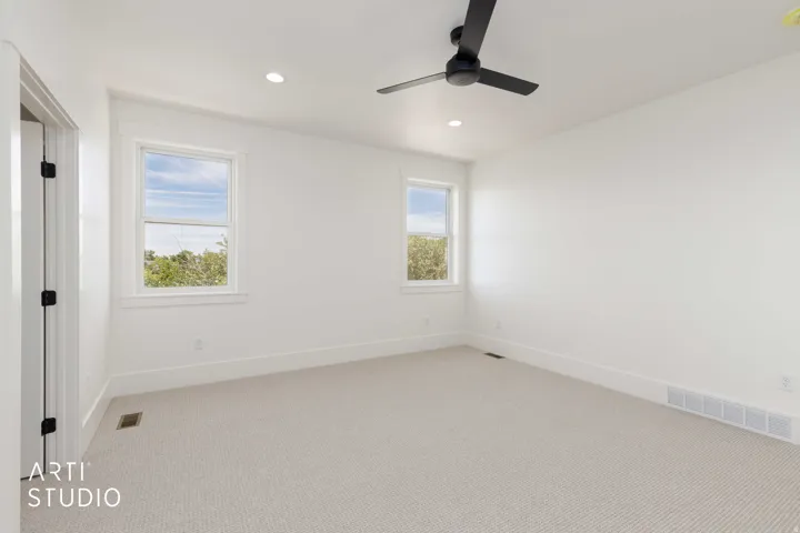 Neutral-toned carpeting complements the white walls and trim in this room